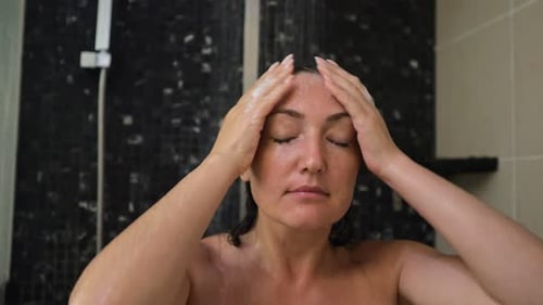 Woman Washing Hair in Shower with Water