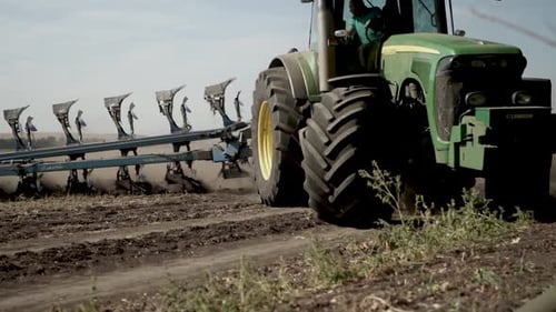 Tractors plowing the field in Ukraine