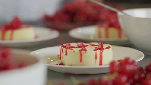 Preparing Dessert with Berries and Red Sauce
