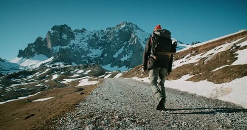 Man Hike on Tourist Trail with Backpack on Winter Mountain Travel Adventure