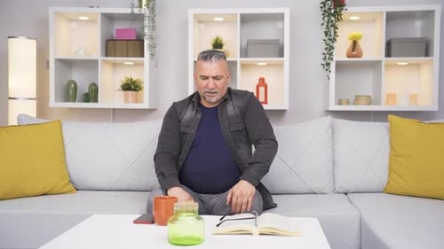 Man Rubbing Stomach Due to Discomfort at Home