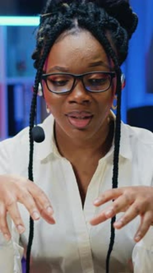 Woman Talks to the Camera Wearing White Shirt