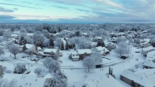 Winder wonderland in American neighborhood with White House’s and snow-covered roofs. Aerial