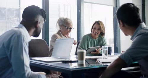 Meeting in office, diverse colleagues discussing project with laptops and coffee