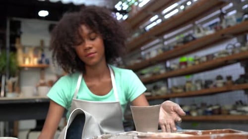 People Creating Pottery in Studio. Female artisan creating handmade ceramics in pottery workshop