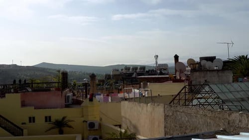 On a warm, sunny day, Fez, Morocco, presents a magnificent panoramic view, with rows of houses and t