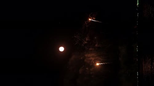 Gleaming Night Fireworks Display Over the Ocean Creates a Fantastic Celebration. Vertical