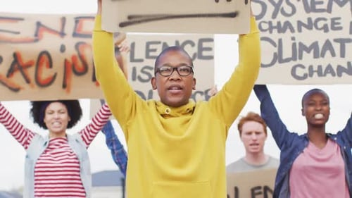 Diverse Group Protests and Marches with Signs