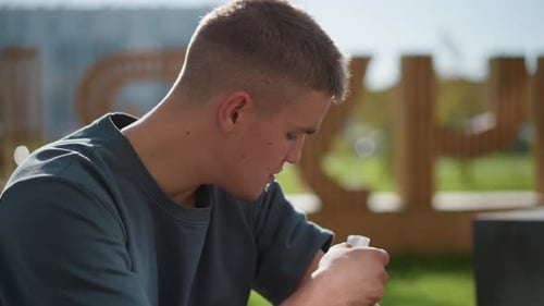 Side View of Boy Enjoying Outdoor Sunlight While Applying Nicotine Patch