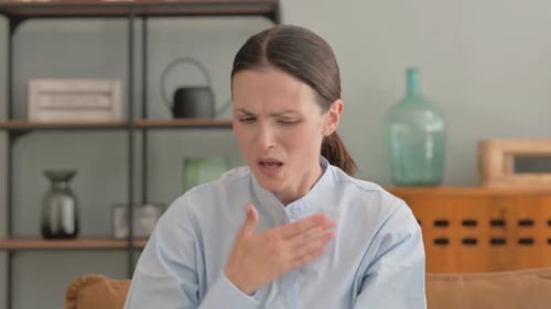 Woman Coughing into Hand Indoor Daytime