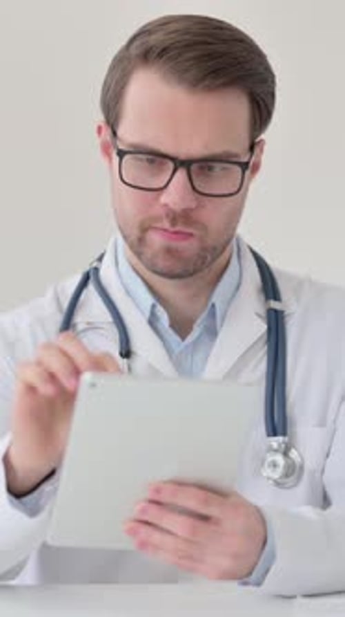 Focused Doctor Using Tablet in Office Environment