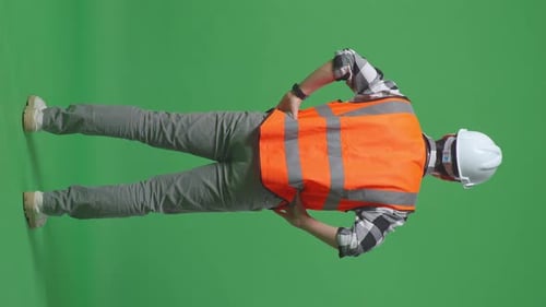 Back View Of A Male Engineer Looking Around While Standing With Arms Akimbo In The Green Screen