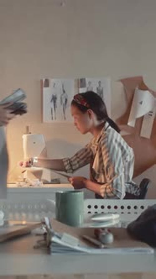 Woman Sewing at Machine in Cozy Workplace