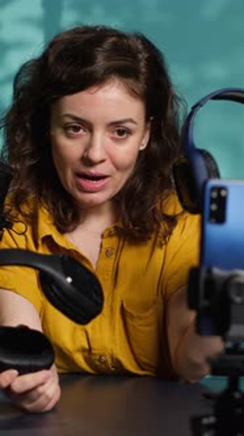 Woman Reviewing Black Headphones for Streaming Video