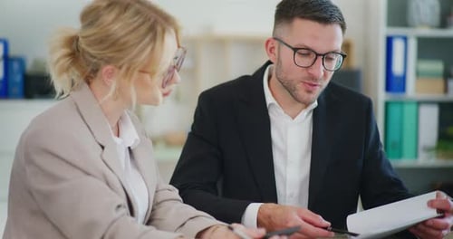 Professionals Reviewing Documents in a Modern Office
