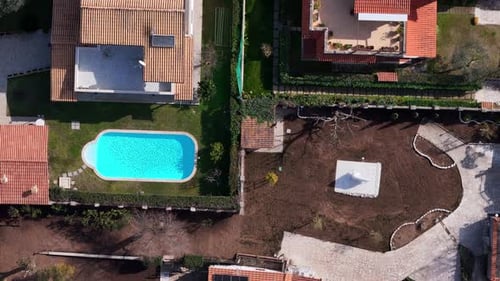 Stunning aerial view of a residential neighborhood featuring a serene swimming pool and beautifully