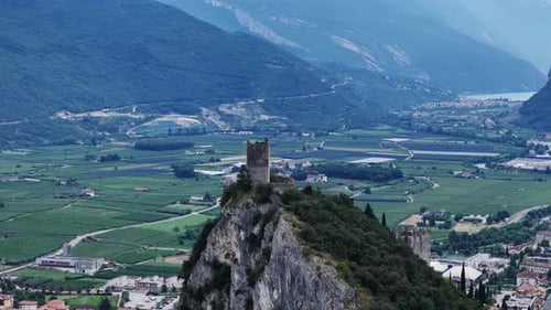 Camera panning over beautiful landscape showing medieval castle ruins on mountain peak