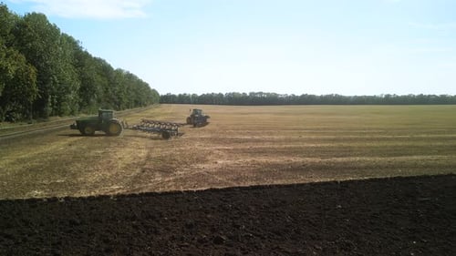 Tractors plowing the field in Ukraine