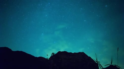 Majestic Night Sky Unveiling Over Mountain Silhouette