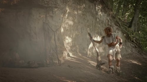 Portrait of Primeval Caveman Wearing Animal Skin and Fur Hunting with Wooden Club Prehistoric Fores