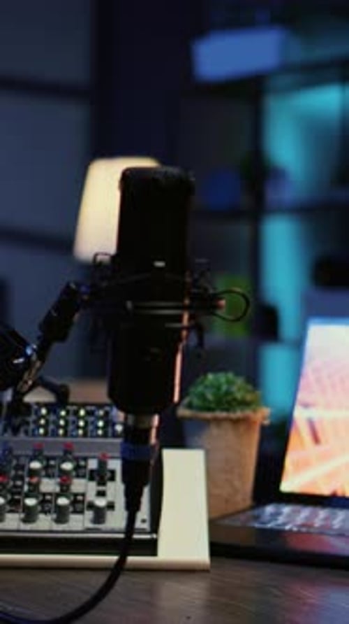 Vertical Video Zoom in on Professional Mic in Dimly Lit Studio Used for Recording Audio During