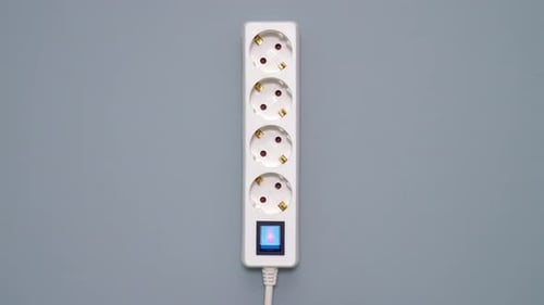 Hand Plugs in a Black Cord to Extension Cord