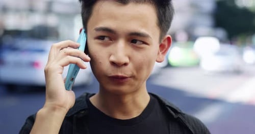 4k video footage of a young man talking on a cellphone while out in the city