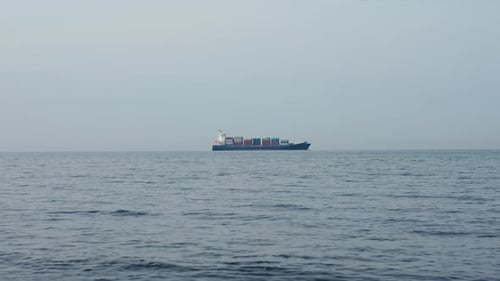 Cargo Ship on Sea Horizon
