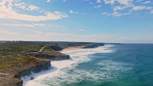 Aerial footage captures the dramatic interplay between land and sea, showcasing the raw, natural pow