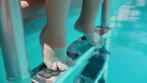Child Standing on Swimming Pool Ladder Steps