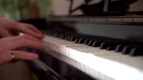 Male Pianist playing on a beautifully rustic old piano, student playing piano with close up keys. Cl