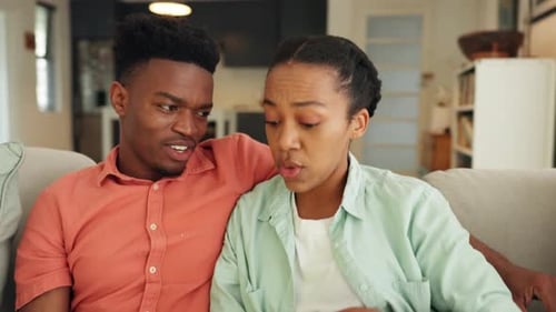Couple Enjoying Movie Together on Couch at Home