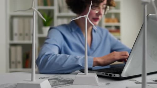Electricity, Design Engineer Sitting At Planning Desk With Laptop Design Engineer Office With Plan