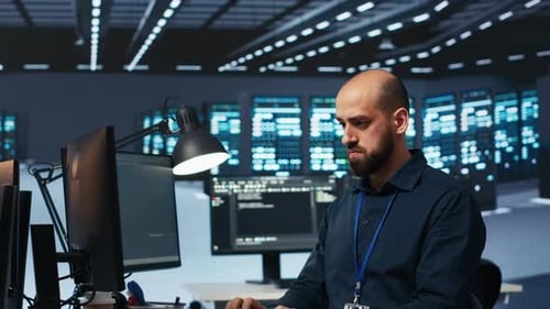 Man Coding at Computer in Data Center