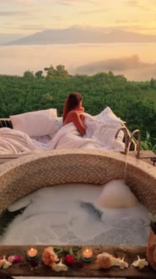 Woman Relaxes in Bathtub with Ocean View Enjoying Water and Sky Landscape