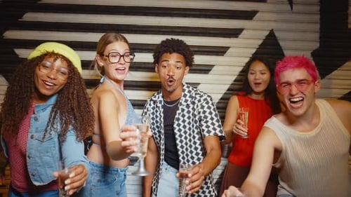 Diverse group of friends cheers with champagne