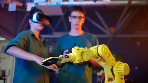 Young Adults Working with Robotic Arm and VR Headset