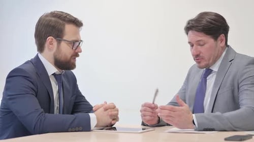 Middle Aged Businessman Talking with Customer in Office