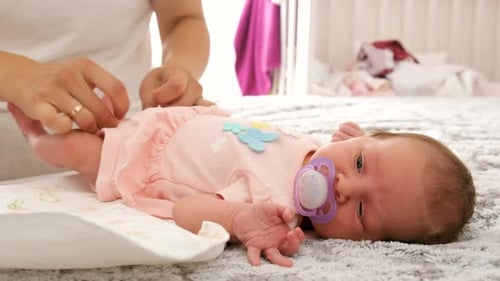 Close Up of Baby on Blanket with Pacifier