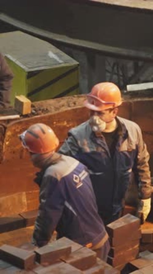 Workers on an Industrial Site Engaged in Various Heavy Machinery Operations and Tasks Stock Clip