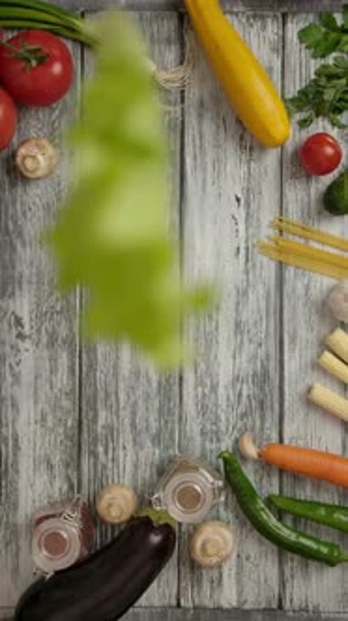 Vertical of Crop People Dropping Down Lettuce Sheets on Wooden Table