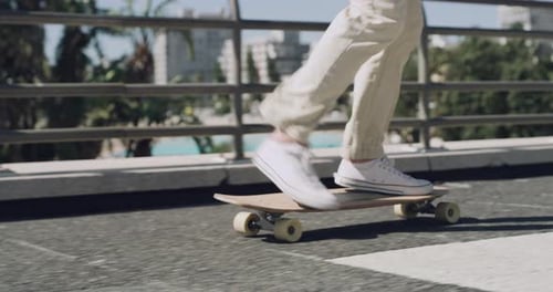 4k video footage of an unrecognisable man skateboarding against a city background