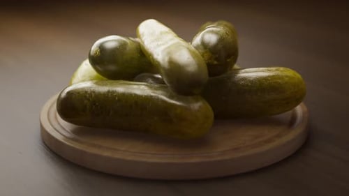 Fresh Green Pickles on Wooden Board