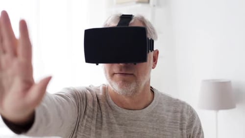 Senior Man Experiences Virtual Reality in Living Room