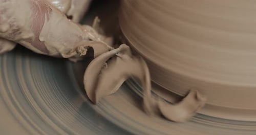 Hands Shaping Clay on Pottery Wheel Close Up
