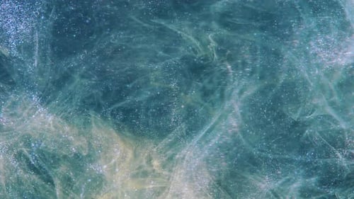 Abstract Swirling Blue and Gold Glitter Particles