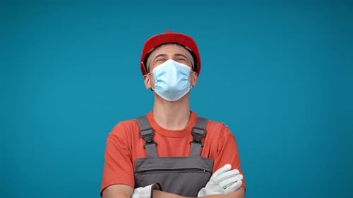 Construction Worker Smiles Wearing Hard Hat and Mask