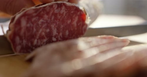 Slicing a Delicious Italian Style Salami Close Up