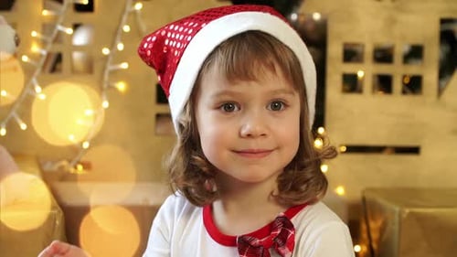 Smiling Child Celebrates Christmas with Santa Hat