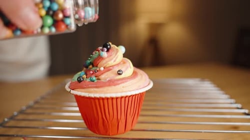 Decorating a Colorful Cupcake with Sprinkles